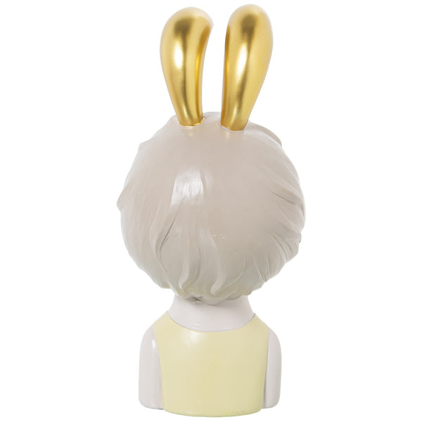 Estatueta dourada de menina chiclete