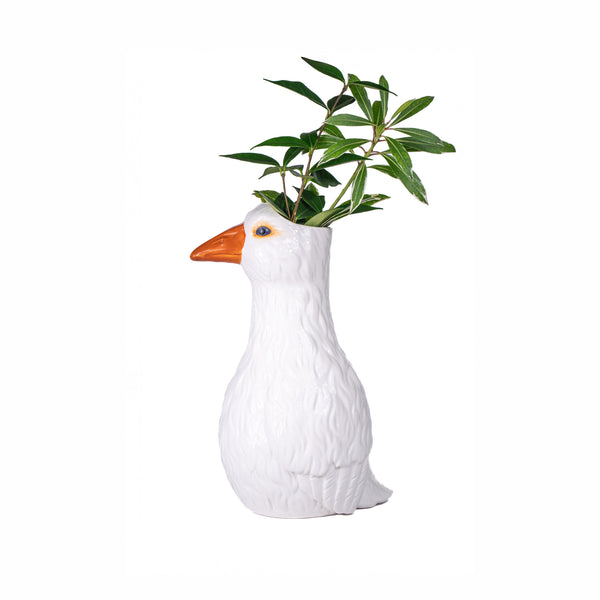 Jarrón ganso blanco con plantas verdes decorativas