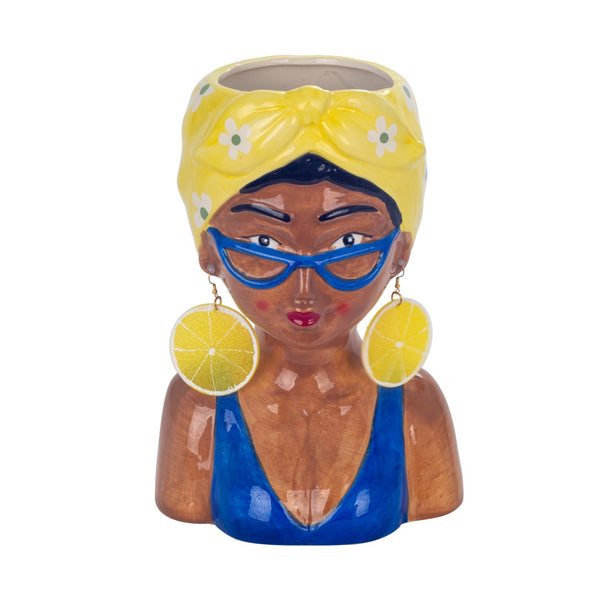 Jarrón decorativo de cerámica con forma de mujer y pañuelo amarillo.